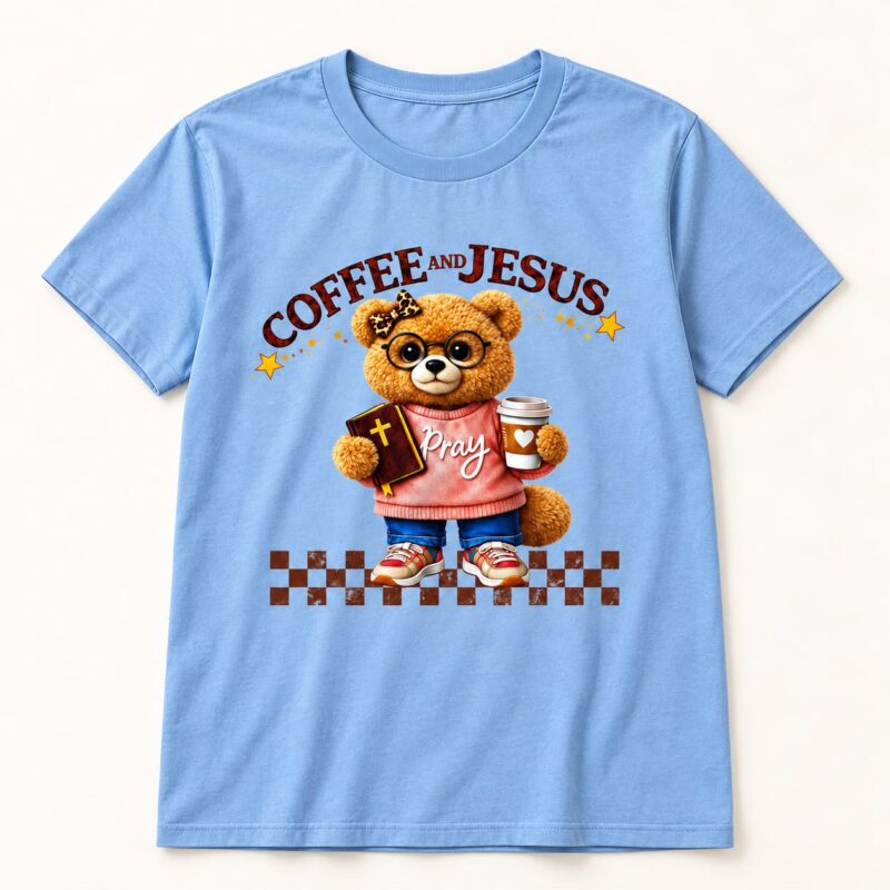 front of the blue Coffee and Jesus T-shirt with teddy bear, Bible and coffee cup artwork