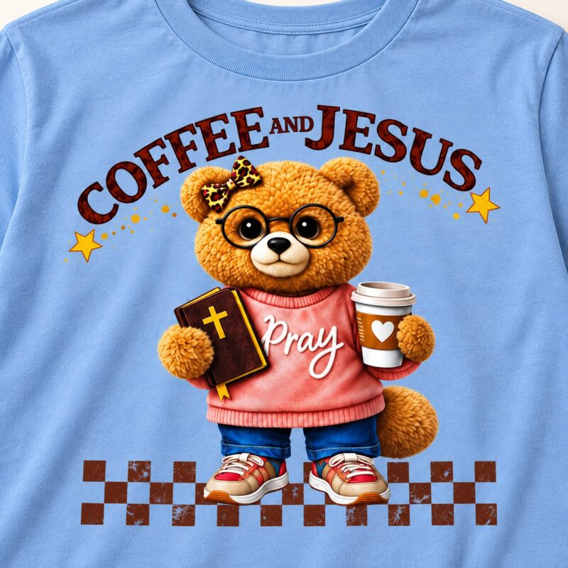 print detail of the blue Coffee and Jesus T-shirt with teddy bear, Bible and coffee cup artwork