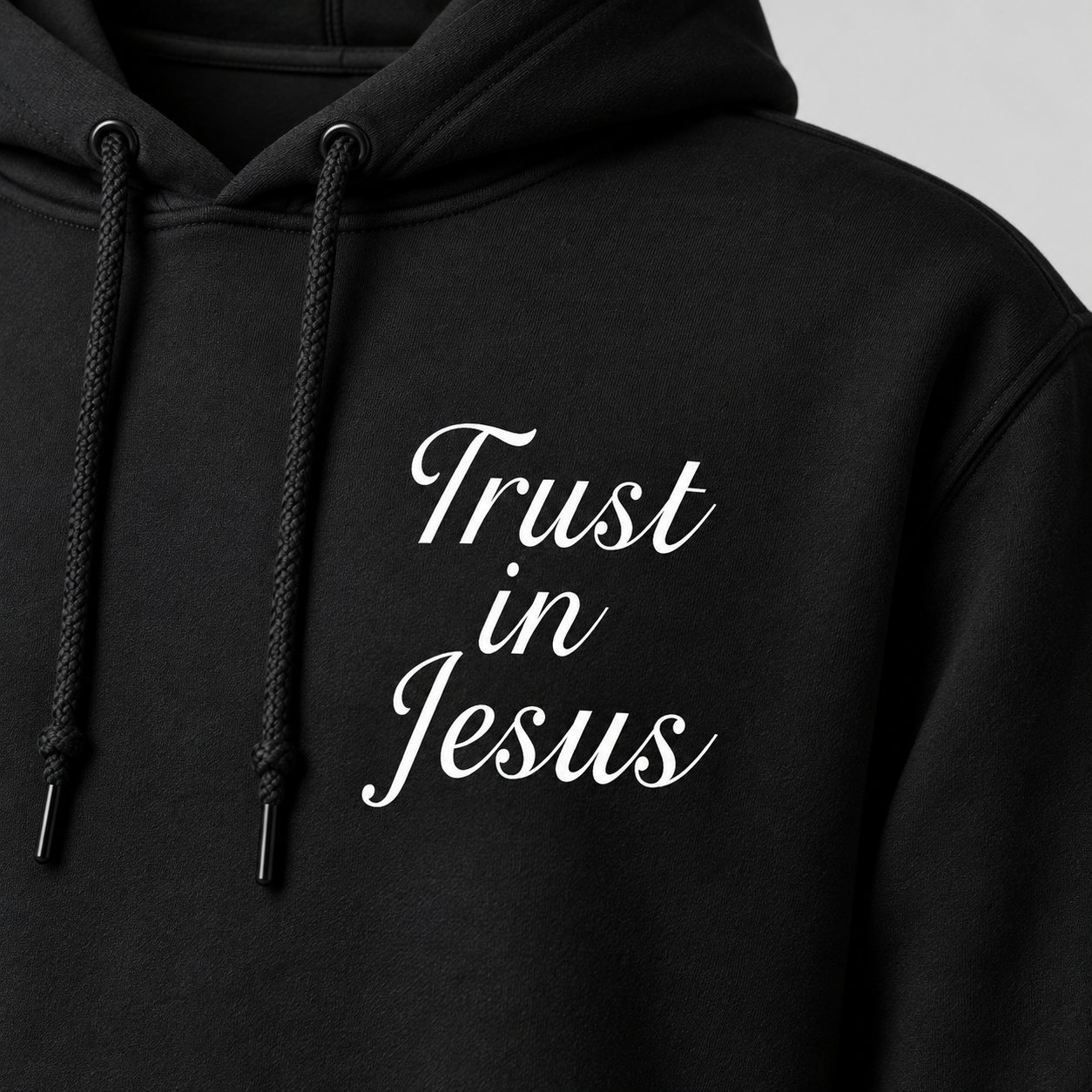 Black Trust in Jesus Hoodie, front print detail, white script chest design